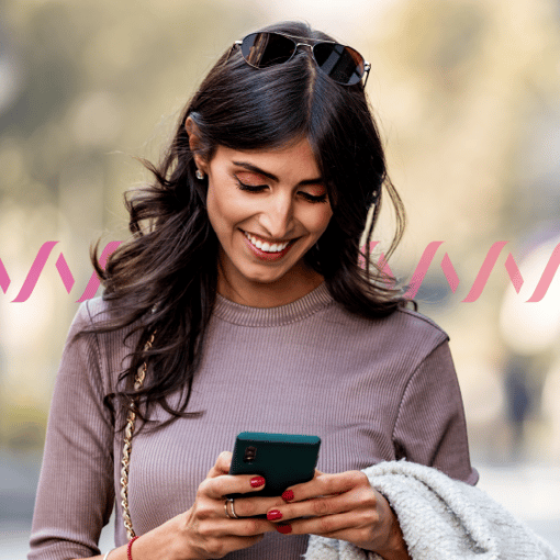 Photo of a woman looking at a mobile phone and smiling